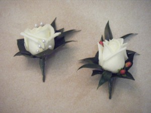 white_rose_buttonholes_with_berries_and_pearls